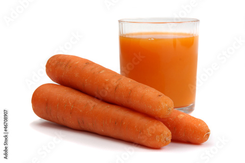 Photo: glass of carrot juice and fresh carrots isolated on white glass of carrot juice and fresh carrots isolated on white