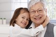 Cute little girl hugging grandmother