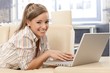 Young woman with laptop smiling