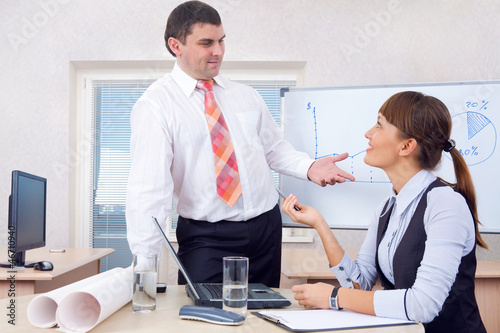 Photo: Man and woman working in office Man and woman working in office