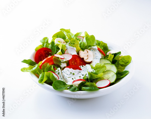 Photo: Salad with tomato, radishes, and dressing Salad with tomato, radishes, and dressing