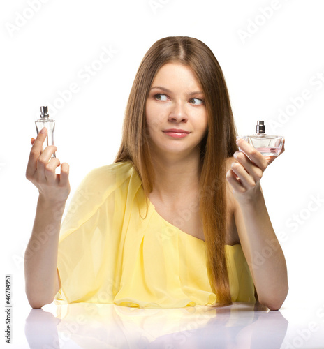 Photo: fashion young woman choicing a perfume on white background fashion young woman choicing a perfume on white background