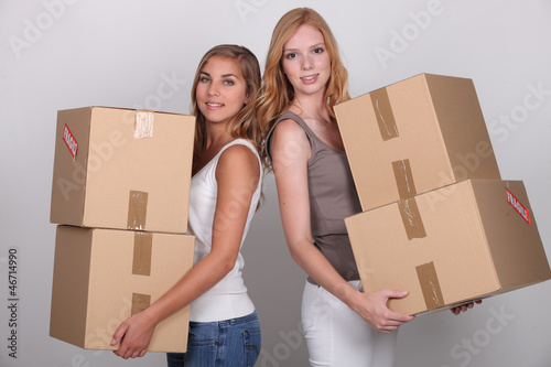 Photo: Girls carrying boxes Girls carrying boxes