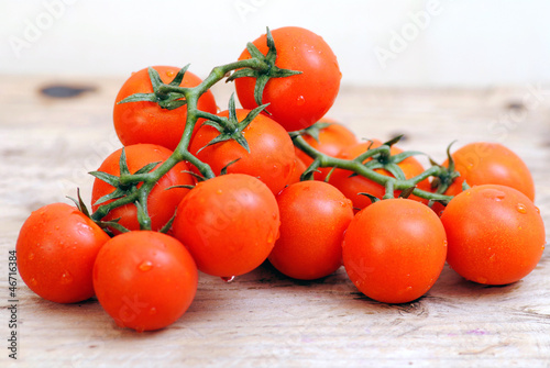 Photo: Tomatoes on white wood rustic background Tomatoes on white wood rustic background