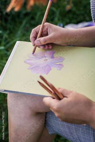 Photo: Girl draws flowers with pastels Girl draws flowers with pastels