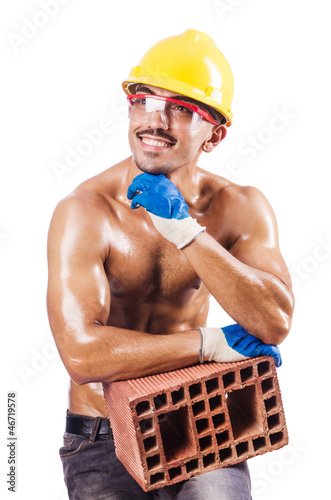 Photo: Muscular builder with bricks on white Muscular builder with bricks on white