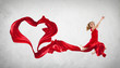 Photo: Dancing young woman with flying fabric Dancing young woman with flying fabric