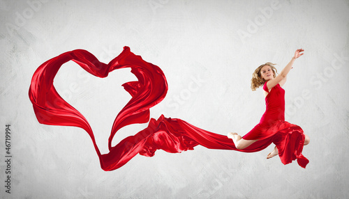 Photo: Dancing young woman with flying fabric Dancing young woman with flying fabric