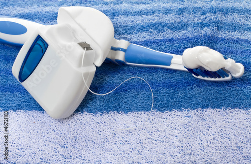 Photo: dental floss and toothbrush on a towel dental floss and toothbrush on a towel