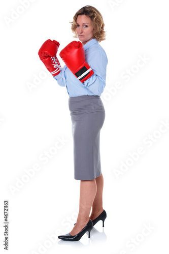 Photo: Businesswoman wearing boxing gloves Businesswoman wearing boxing gloves