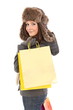 Woman in winter clothes with gifts and shopping bags smiling
