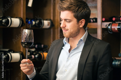 Photo: Man tasting a glass of red wine Man tasting a glass of red wine