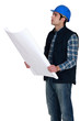 Construction worker verifying a building drawing