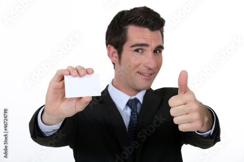Photo: Thumbs up form n executive with blank business card Thumbs up form n executive with blank business card