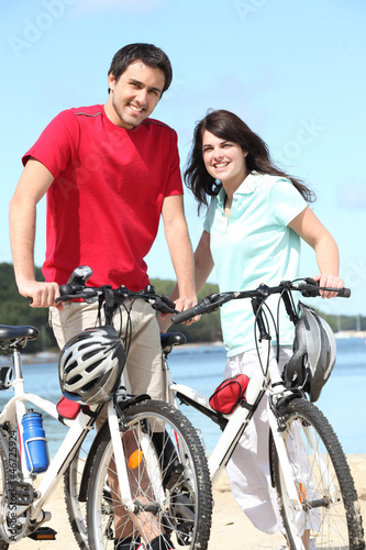 Photo: Couple riding bicycles Couple riding bicycles