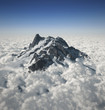 Foto: Mountain peak over the clouds Mountain peak over the clouds