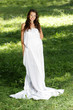 Photo: young happy woman in long white dress on natural background young happy woman in long white dress on natural background
