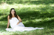 Photo: young happy woman in long white dress on natural background young happy woman in long white dress on natural background