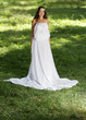 Photo: young happy woman in long white dress on natural background young happy woman in long white dress on natural background