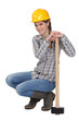 craftswoman holding a huge hammer