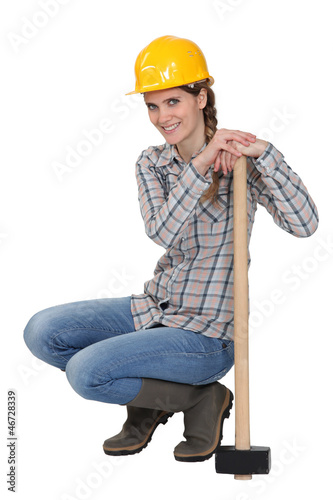 Photo: craftswoman holding a huge hammer craftswoman holding a huge hammer