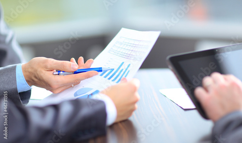 Photo: Business team analyzing market research results together Business team analyzing market research results together