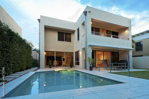 Photo: Luxury home with backyard and pool Luxury home with backyard and pool
