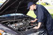 Car mechanic working in auto repair service.