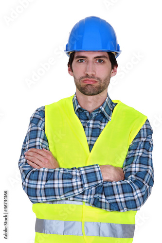 Photo: bored craftsman posing arms crossed bored craftsman posing arms crossed