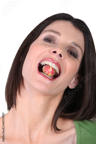 Photo: Woman eating a candy Woman eating a candy