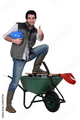Photo: Happy building worker isolated on white background Happy building worker isolated on white background