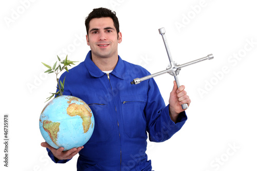 Photo: A mechanic with a globe. A mechanic with a globe.