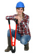 Woman kneeling by bolt cutters