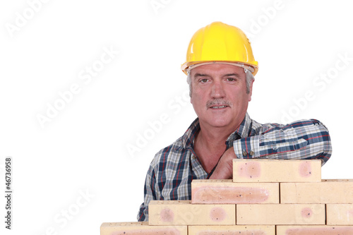 Photo: Artisan leaning on stack of bricks Artisan leaning on stack of bricks