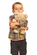 Sad kid hugging teddy