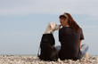 beautiful woman sitting with dog looking each other