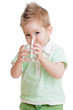Little kid or child drinking water from glass isolated on white.