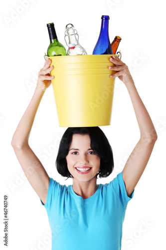 Photo: Beautiful young woman holding recycling bin Beautiful young woman holding recycling bin