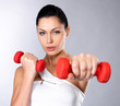 Foto: beautiful young woman with dumbbells beautiful young woman with dumbbells