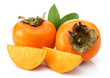 Slice persimmons with green leaves