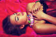 Dreamy sensual romantic girl in red dress lying in bed