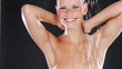 Stunning young woman smiling while enjoying a shower