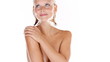 Gorgeous naked woman smiling and rubbing her smooth skin