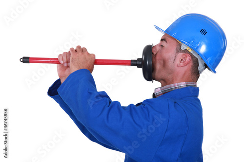 Photo: Plumber unplugging his mouth. Plumber unplugging his mouth.