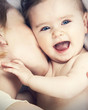 mother kissed her little baby, close-up