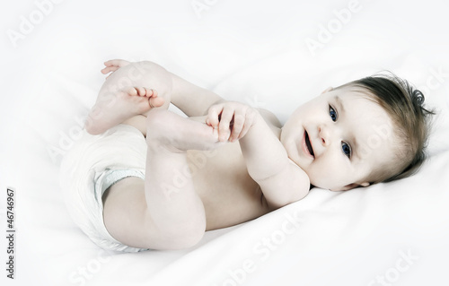 Photo: Portrait of a cute little baby on a white background Portrait of a cute little baby on a white background