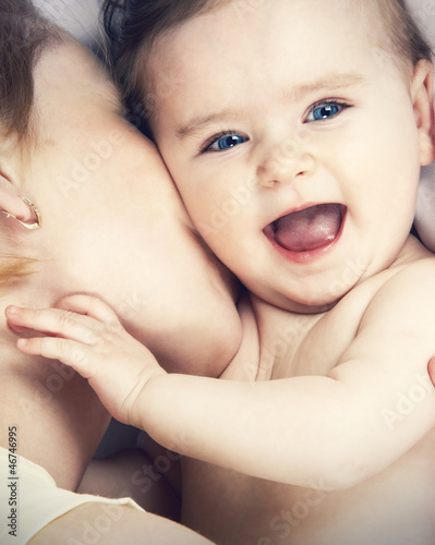 Photo: mother kissed her little baby, close-up mother kissed her little baby, close-up