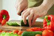 man cutting vegetables for salad