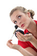 Blond woman applying blusher