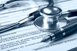 Stethoscope on medical billing statement on table